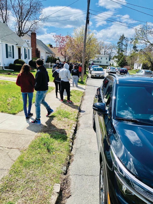 LINED UP: More than 40 prospective buyers lined the sidewalk outside 76 Community Drive in Cranston last Saturday to look at a house that went on the market April 14. It was listed for $250,000 and reportedly is now under contract.