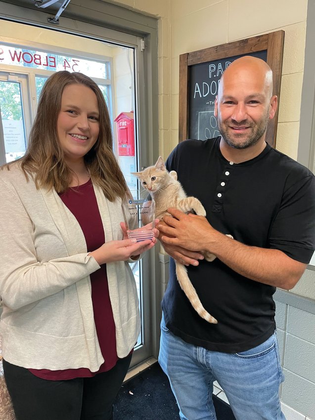 FOR THE ANIMALS: Luca Danni founder Fred Magnanimi receives the Stanley H. Mason Award from Rebecca Baylies, executive director of the Providence Animal Rescue League.