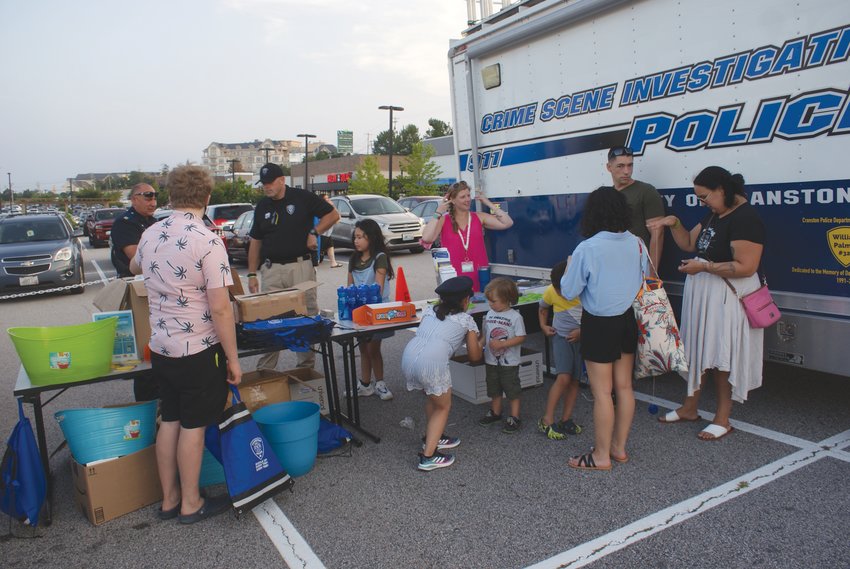 GETTING TO KNOW YOU: Members of the Cranston Police Department met with community members at just one of the informational tables set up during the Garden City Summer Concert last Wednesday.