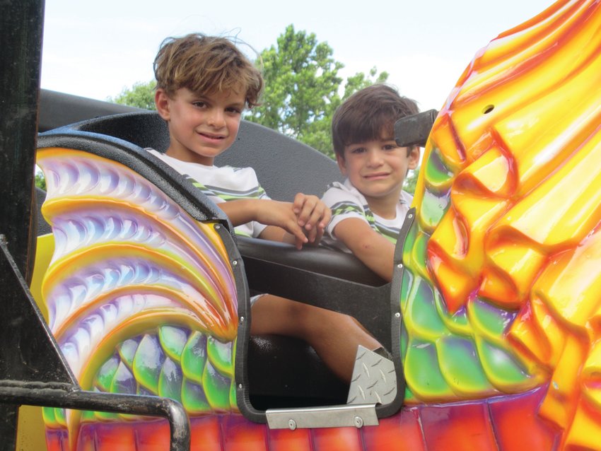 SUPER SMILES: Countless children were all smiles during the fest and festival as they enjoyed a variety of rides like the Orient Express.