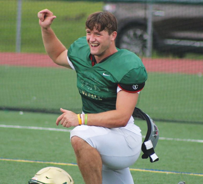 GETTING STARTED: Bishop Hendricken defensive lineman Brandyn Durand has a laugh during warmups at a recent practice. Durand and company are looking to defend their  state championship this year against one of the toughest schedules the team has ever faced.