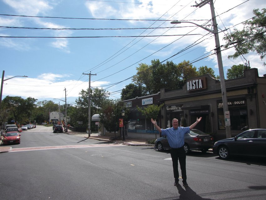 IN THE VILLAGE: Mayor Ken Hopkins pauses while crossing Broad Street during a recent interview with the Herald. Pawtuxet Village, which will host the Gaspee Days 250th anniversary celebration next year, has been the focus of the administration&rsquo;s latest neighborhood revitalization project.