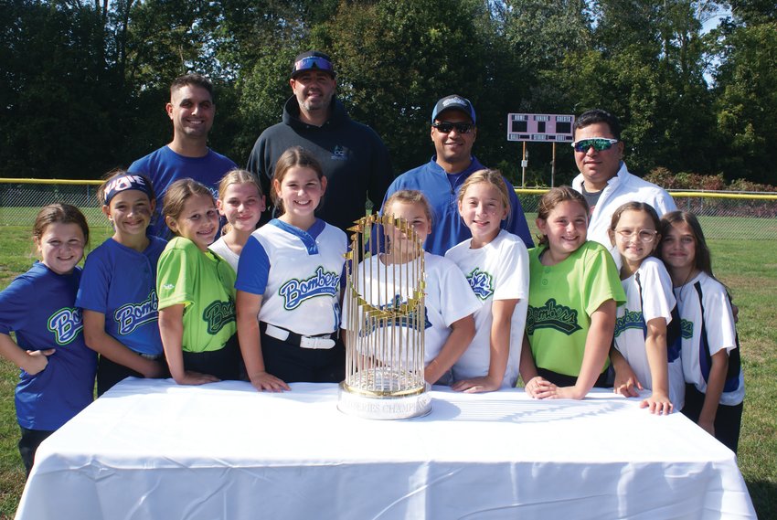 FOR THE TEAM: Pictured with the 2018 World Series trophy at Brayton Field are  coaches and players from the CLCF Bomber&rsquo;s Travel Team (10 U).