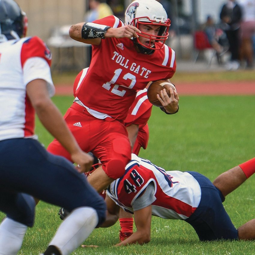 RUSH TO THE WIN: Toll Gate quarterback Joe Pankowicz picks up some yards on a rush last week against Central Falls/Blackstone Valley Prep. The host Titans would roll to their first win by a score of 24-8. Pankowicz threw for two touchdowns while rushing for another.