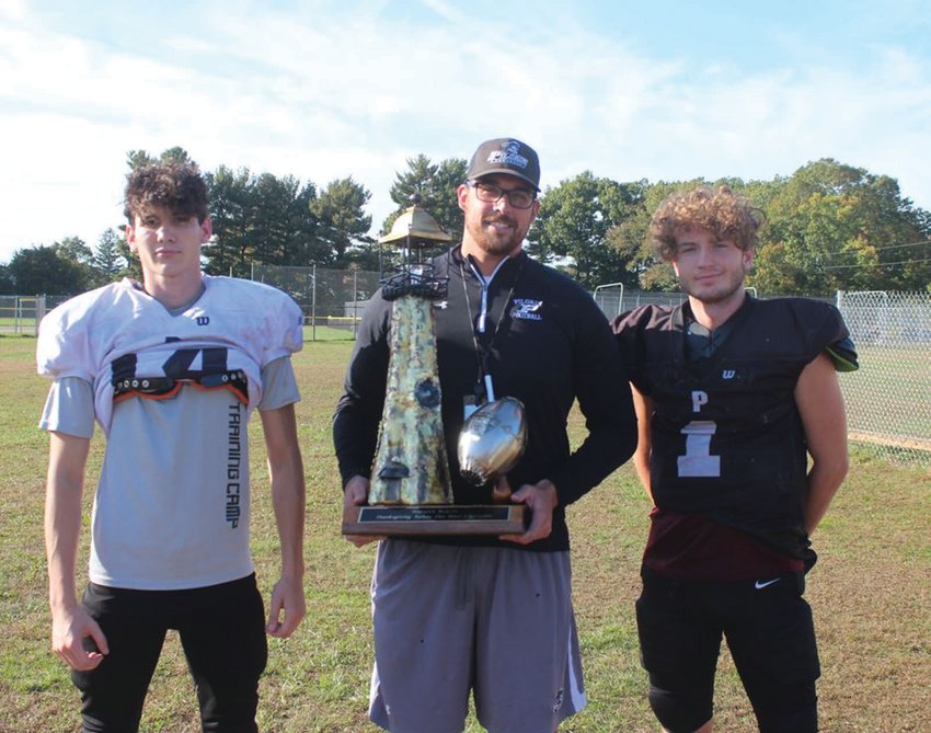 TURKEY DAY: Pilgrim head coach Blake Simpson (center) along with Connor Widmer (right) and Brady Burke (left),  show off the new Beacon Bowl trophy which will be on the line against Johnston.