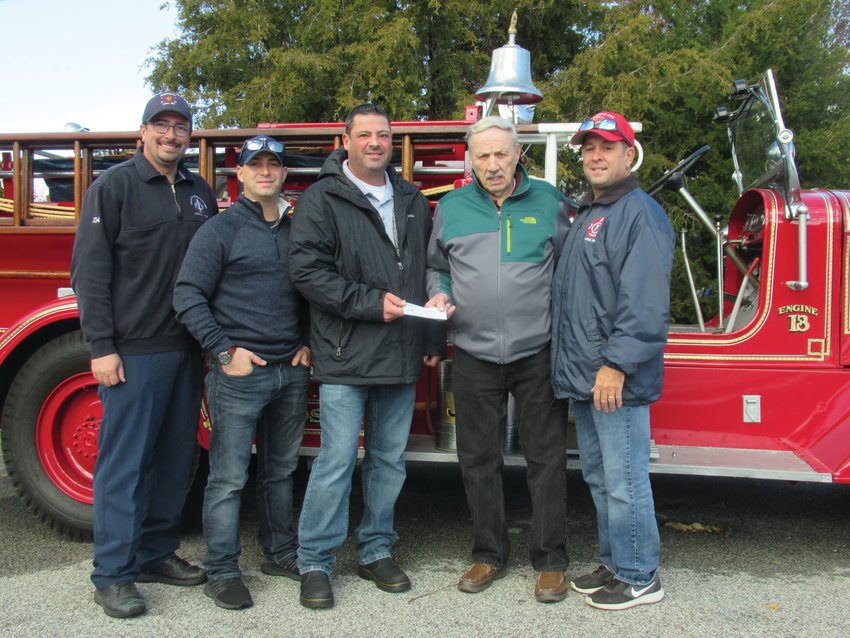 HISTORIC HAPPENING: Former JFD Chief Alan Zambarano presents JFD Lt. Jon Pistacchio with a check from the former Johnston Hose&nbsp; Volunteer Company No. 1 that local 1950 will use in its continuing giving back to the community. Also taking part were Firefighters Scott Thacker, Chris DelFino and Lt. David Pingitore.