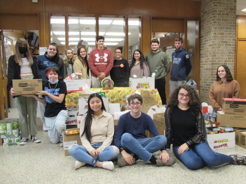 COLOSSAL COLLECTION: Members of SADD (Students Against Dangerous Decisions) surround the extraordinary collection of food they collected during their annual drive. In front are Ryan Schino, Anthony Gawlik, Emily Klein, Rachel Ixocoptech, Charles Curci and Nicki Aucone. Behind are Gabriella Marandola, Rebecca Clements, Charlene Hohlmaier, Janet Clements, Phil Costantini, Lauren Hill and Gianna Ricci.&nbsp;