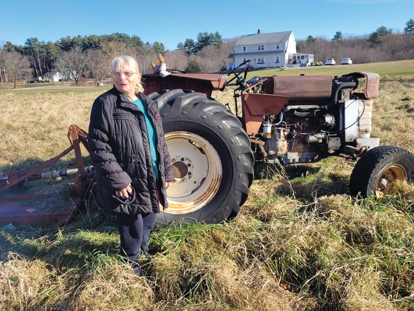 STILL KICKING: Sally Hicks, of Scituate, stands by her old old Massey Ferguson tractor. Neither Sally nor the tractor is ready to quit yet.