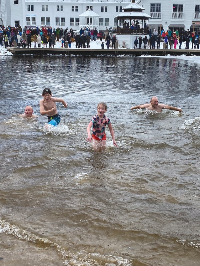 TAKING THE PLUNGE: Grandpa Jerry Shannon, Cousin Tiernan Shannon, Hannah McNally and Uncle Tim Shannon crawl out of the frigid water at the annual &quot;Freezin' for a Reason&quot; plunge in Waterville Valley over Thanksgiving weekend.
