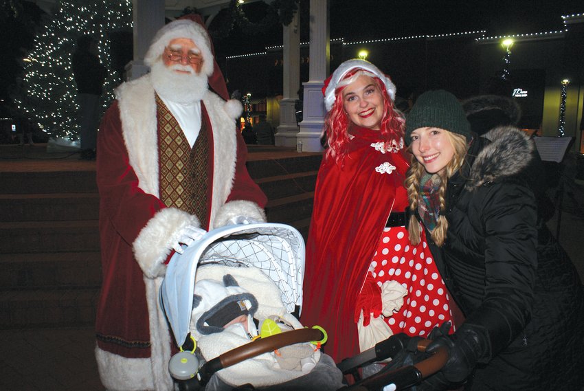 BABY&rsquo;S FIRST CHRISTMAS: Santa Claus enjoyed meeting Jameson Macera, age 4 mos. and his mother, Lauren Macera  during the Holiday Stroll last Friday in Garden City Shopping Center. Santa was joined with his Elf Kringle.
