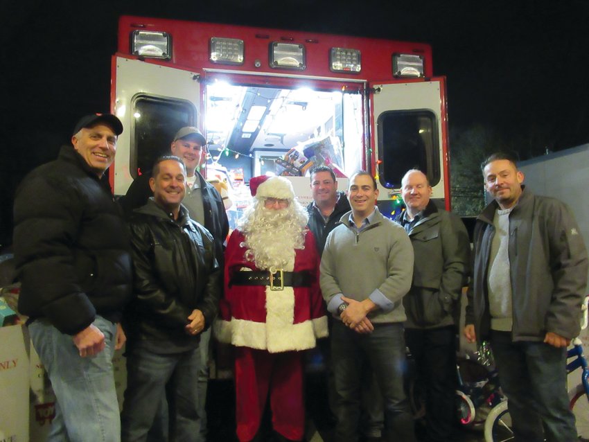 GRAND GIVERS: Santa (Paul Paon) is greeted by Local 1950 leadership officials Sal Martra, Dave Pingitore, Don Roberts, Jon Pistacchio, Keith Calci and John Jasparro