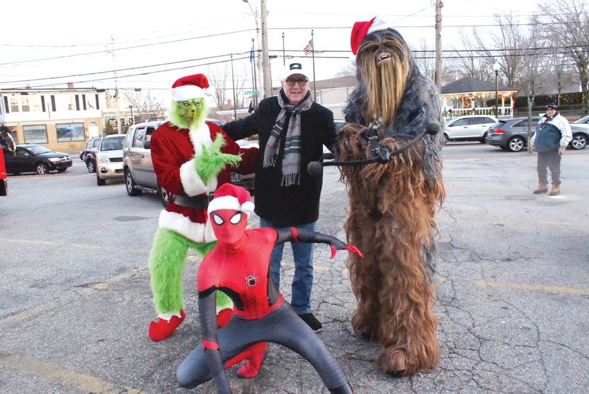 NEW FRIENDS: Mayor Ken Hopkins, with his new friends The  Grinch, Spiderman and Chewbacca, helped deliver toys to those in  need during the St. Mary&rsquo;s Feast Society and Ladies Auxiliary Toy  Drive and Give A Way.