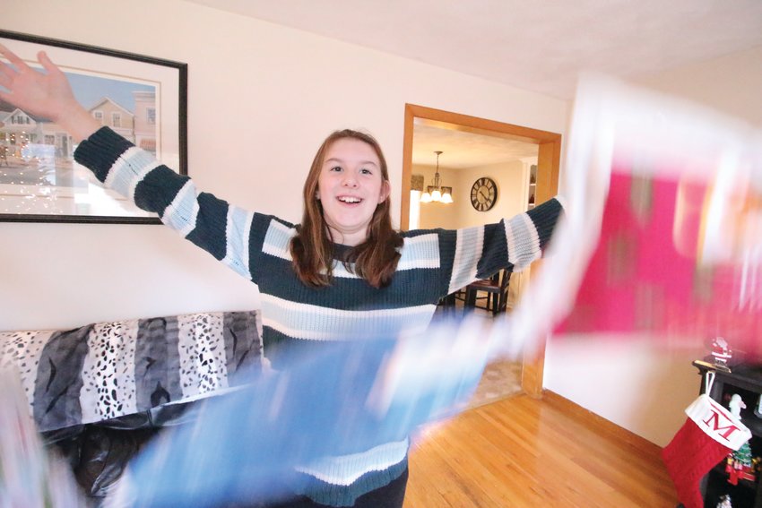 PILLOW FLIGHT: On a photographer&rsquo;s cue, Rachel Dias tosses pillows she made. Her  younger brother, Mathew, was most willing to participate in the activity if only he had  been asked. (Warwick Beacon photos)