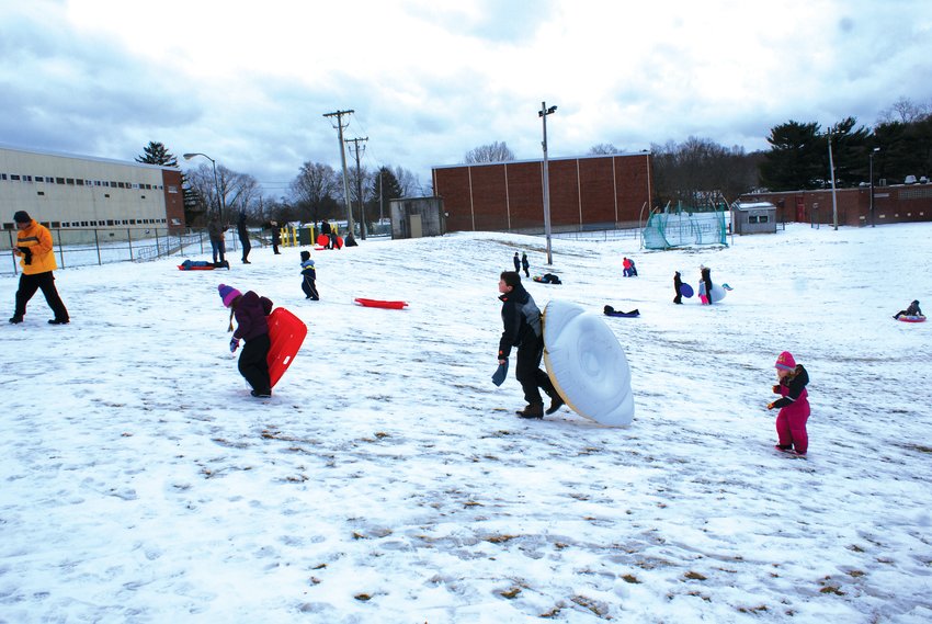 GETTING OUTSIDE TO PLAY: Many sledders took to the hills at Cranston High School West on Saturday.