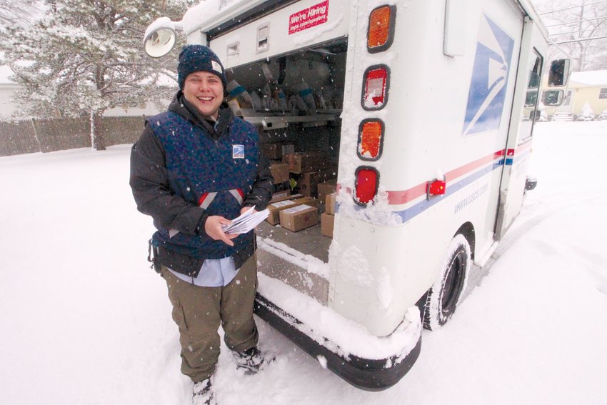 NO SLOWING DOWN THE MAIL: Kayla Cilley, who filled in for the postman who handles  the route covering the Warwick Beacon office on Warwick Avenue collected and  delivered mail of Friday.