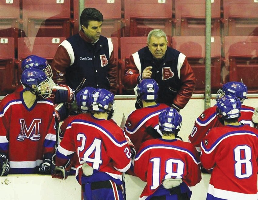 MAKING HISTORY: Former Mount St. Charles hockey coach Bill Belise talks strategy with his team in this photo from  his coaching days. The legendary coach passed away last week at 92 years old.