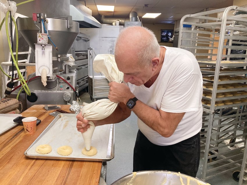 PREP WORK: The Original Italian Bakery Owner, Donald DePetrillo, makes zeppoles out of the prepped batter. There are 24 zeppoles per tray.