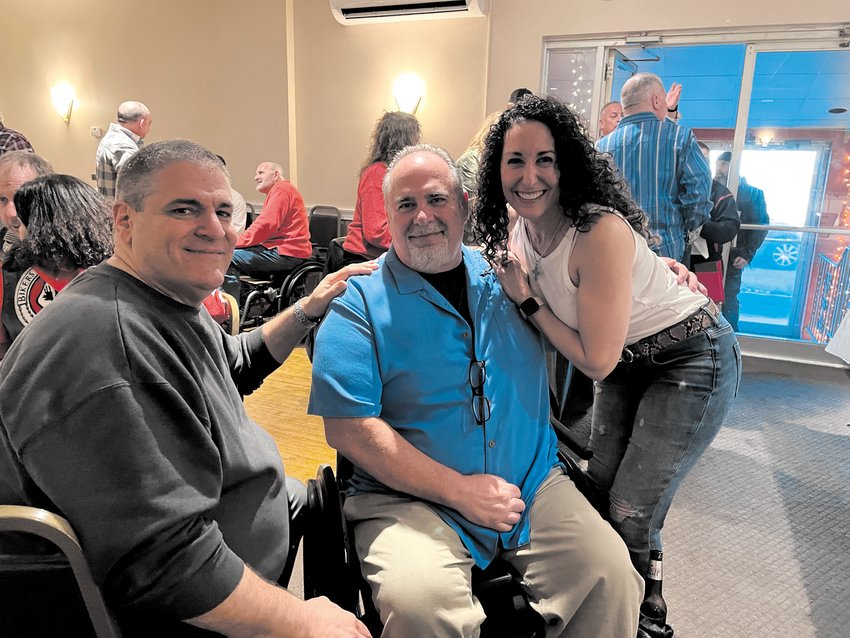 TRUE FRIENDS IN NEED, INDEED: Comedian John Perrotta, Al Saccocia and Kimberly Zompa-Sanzi take a moment to share a smile at the fundraiser for Al on Feb. 27.