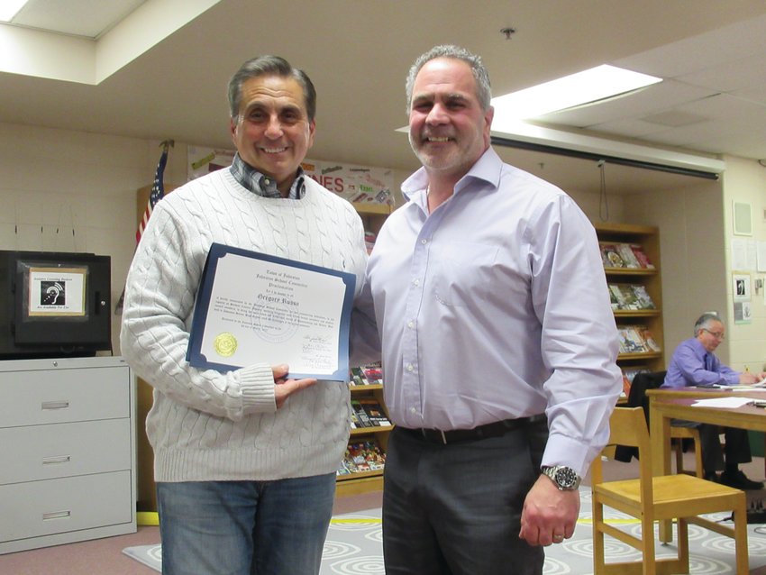 AWESOME AWARD: Long-time Johnston Senior High School faculty member Greg Russo (left), who has been known as &ldquo;Mr. JHS Panther&rdquo; for years, displays the special proclamation he received from Vice Chairman Joseph Rotella at last week&rsquo;s school committee meeting.