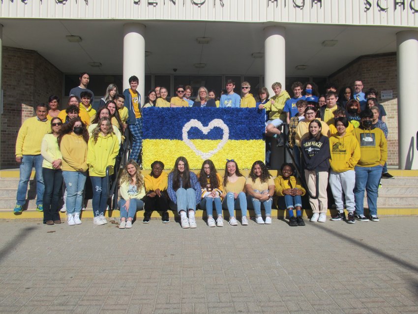 PANTHER PRESENTATION: This was the special scene last week outside Johnston High School when students, faculty and staff unveiled this handmade flag to show support along with raising money for families in the country of war-ravaged Ukraine.