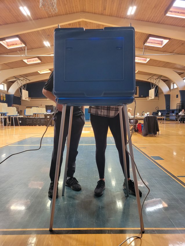 CIVIC DUTY: A Johnston mother brought her son to the polls to vote on a $215 million bond to fund new school building projects. The referendum passed overwhelmingly.