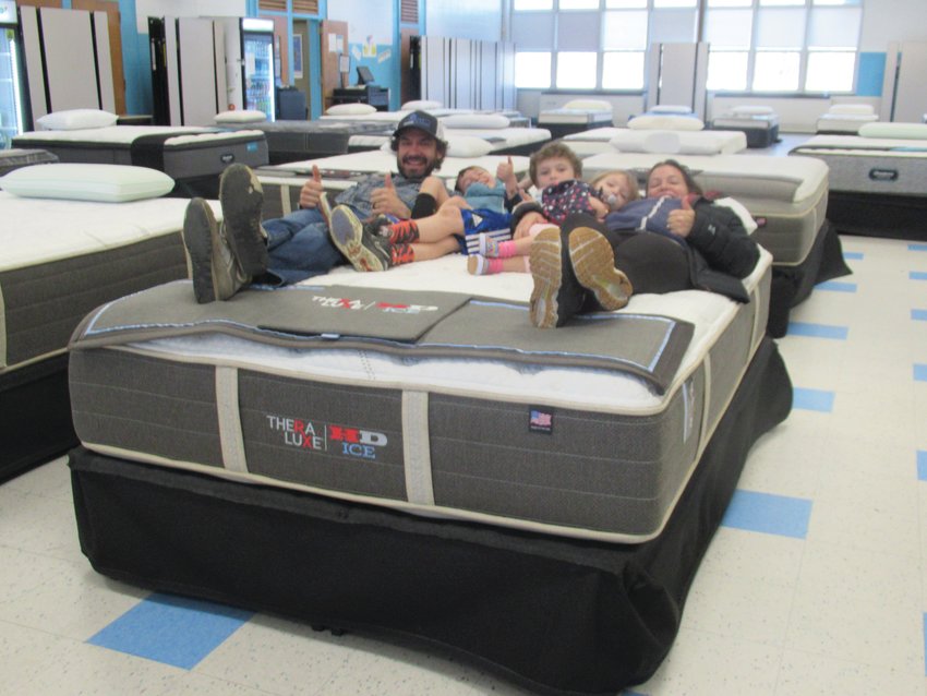 FIRM FUN: The Oakley family from Narragansett &mdash; Justin, Jamie, Zach, Miles and Fiona &mdash; offered a thumbs about this mattress they tried out Saturday during the JHS Music Department&rsquo;s 5th Annual Mattress Sale.