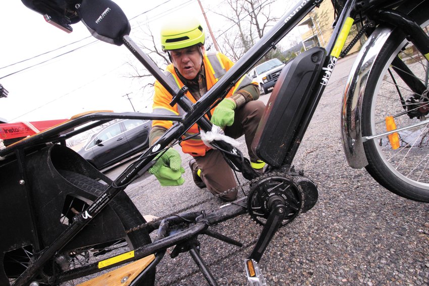 THE POWER OF CHANGE: Bob Walker points to the engine and the battery pack on the electric bike he built.  (Warwick Beacon photos)