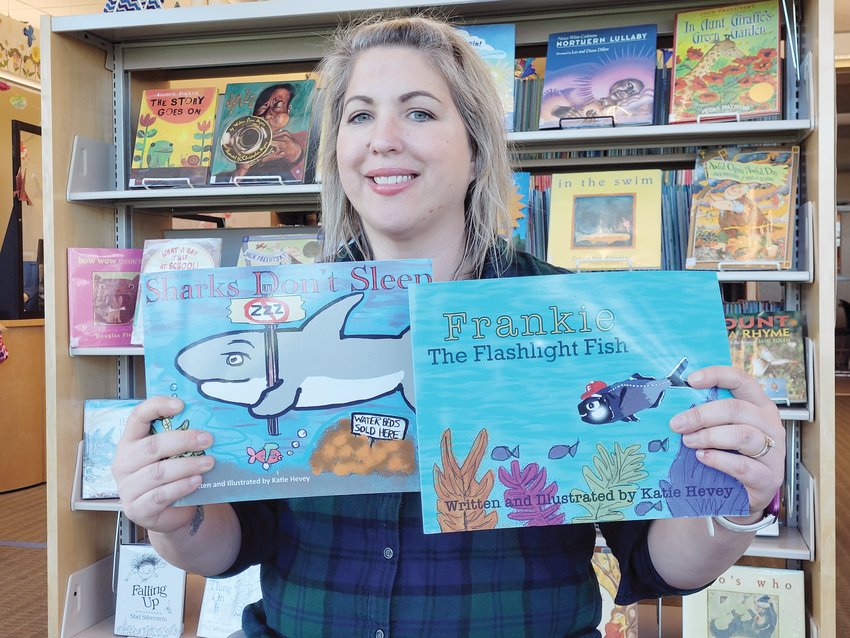 OCEAN STATE AUTHOR: Katie Hevey sat for an interview among the stacks of children&rsquo;s books downstairs at the Marion J. Mohr Memorial Library in Johnston. She brought copies of her two books, &ldquo;Frankie The Flashlight Fish&rdquo; and &ldquo;Sharks Don&rsquo;t Sleep.&rdquo;