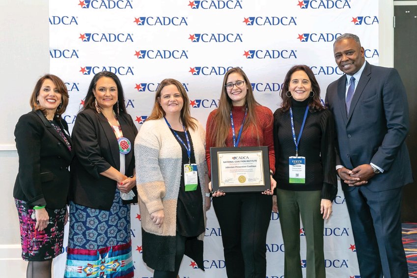 NATIONAL AWARD: From left to right, Pat Castillo &ndash; National Coalition Institute Director, Jeannie Hovland &ndash; CADCA Board Member, Andrea Paiva, Kaitlyn Maggiore, Patricia Sweet &ndash; Johnston Prevention Coalition and General Barrye Price &ndash; CADCA President &amp; CEO.