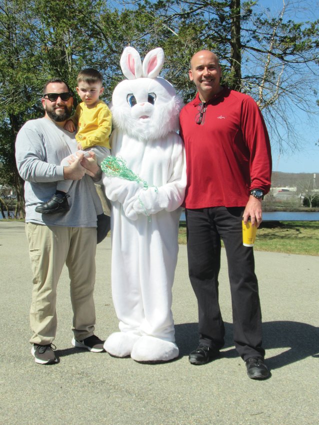 BUNNY&rsquo;S BUDDIES: Joseph Moscarelli and his son Julian, 3, and Johnston Parks and Recreation Director Chris Correia enjoy lighter moment with the Easter Bunny during last week&rsquo;s special Bunny Walk inside War Memorial Park.