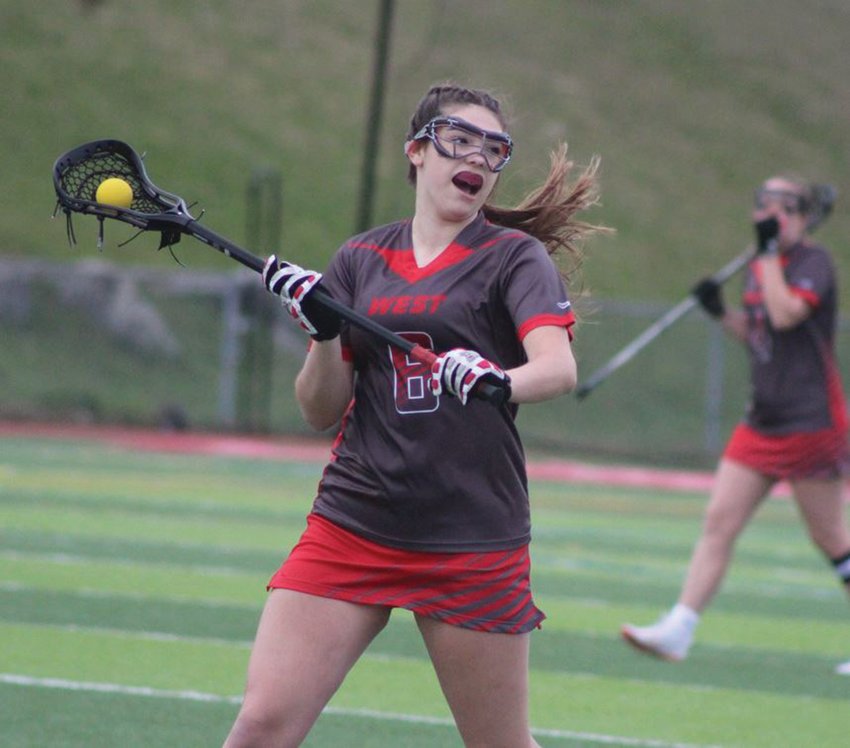 OVERTIME THRILLER: Cranston West&rsquo;s Sarah Perreault looks to pass the ball against Toll Gate last week at home. The visiting Titans would come back to beat the Falcons 8-7 in a double-overtime thriller. West fell to 1-2 with the loss. (Photos by Alex Sponseller)