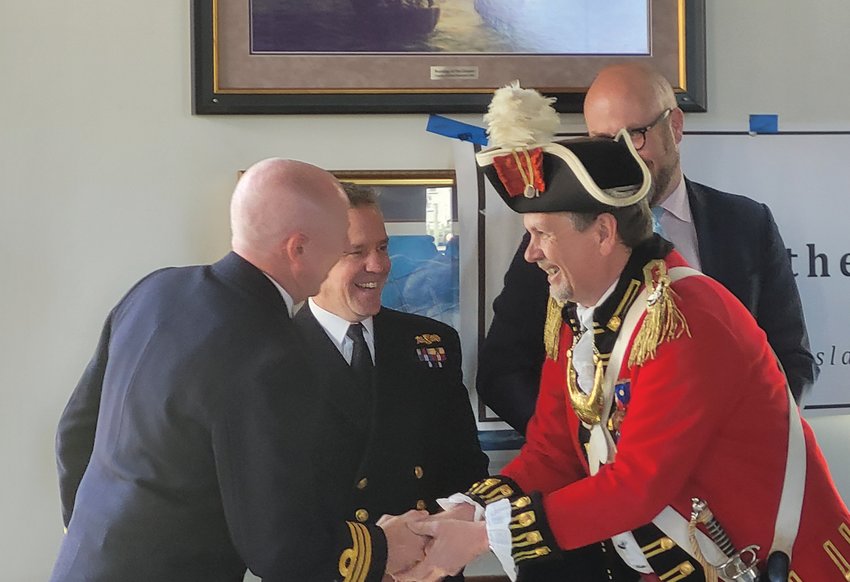 ACROSS THE POND PEERS: Col. Ron Barnes, Commander of the Pawtuxet Rangers, shook hands with representatives from the British government and Navy &mdash; from left to right, with British Naval Commander Steven White, of Her Majesty&rsquo;s Royal Navy, Commander Simon Rogers, and Consul General for New England Dr. Peter Abbott OBE. (Beacon photo by Rory Schuler)