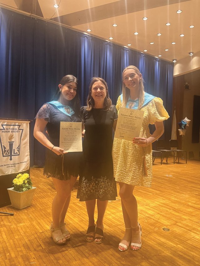Sophia Ribezzo, Emilia Ruggiero and Kelly Dargy, pose for a photo at this year&rsquo;s National Honor Society ceremony at Johnston High School.