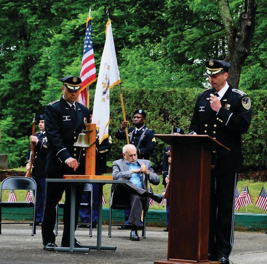 DELIGHTFUL DUTY: As Johnston Police Chief Joseph P. Razza reads the individual names of the 42 Johnston residents who were killed in action during World War II, Korean and Vietnam wars, Deputy Chief Mark Vieira rings the brass bell in their honor.