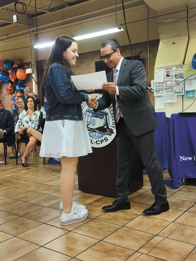 A FOR EFFORT: Ninth grader Azucena Vanegas Espinal receives the Faculty Award for Effort from Executive Director Ramon Torres. (Photo courtesy CPS)