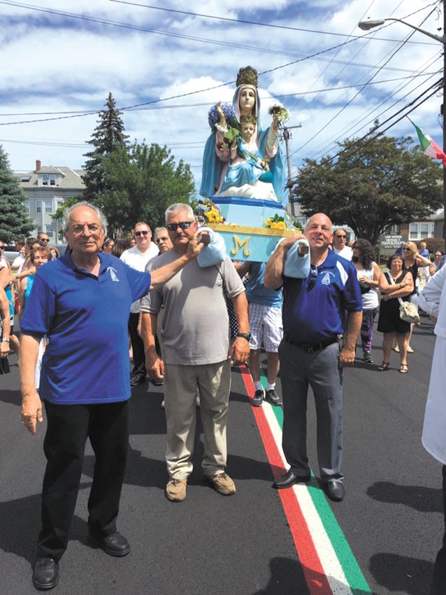 PROCESSION TIME: The statue of Maria Santissima Della Civita is carried down the streets of Knightsville. (Herald file photo)