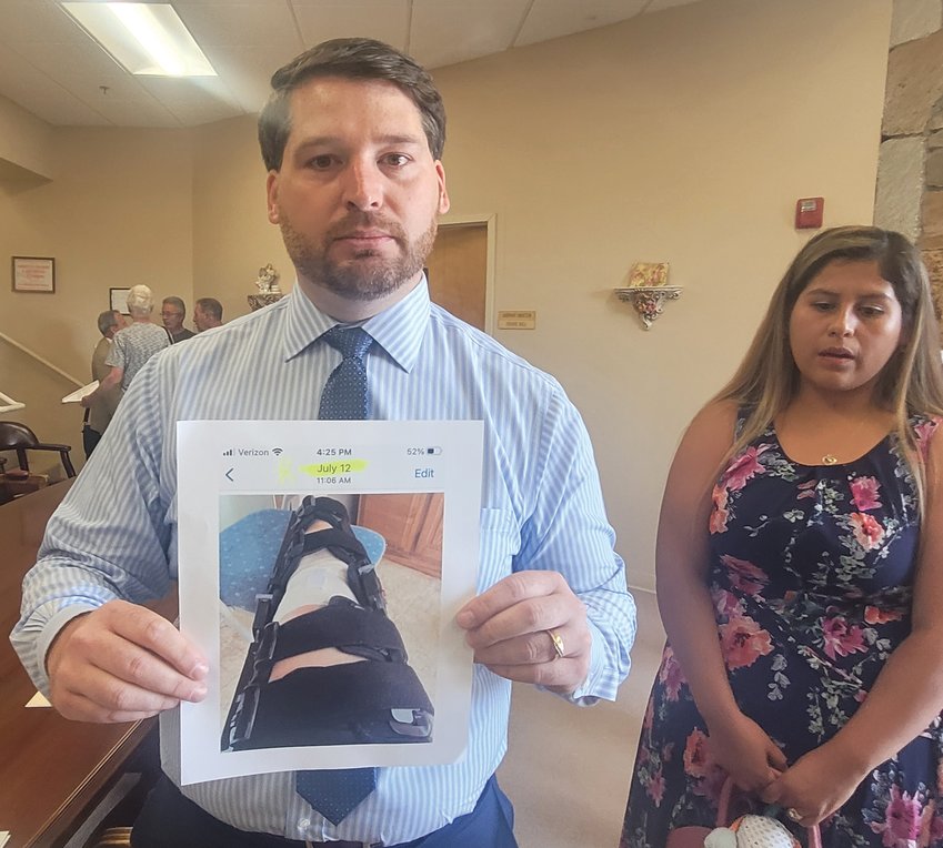 AILING MOM: Dennis Cardillo Jr. holds a photograph of what he says is his mother&rsquo;s post-operative injury dated July 12. The candidate for state representative in District 42 has been accused of living outside the district. He insists he was merely taking care of his mother in Cranston while she recuperated.