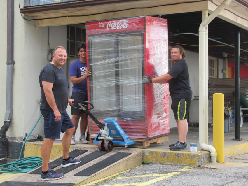 DAN&rsquo;S DUTY: Dan Parrillo (center) and his son Mitchell (right) and Julius DiSanto are taking a huge cooler out of storage that will be used for food items during this weekend&rsquo;s St. Rocco&rsquo;s Feast and Festival that opens Thursday evening in Johnston.