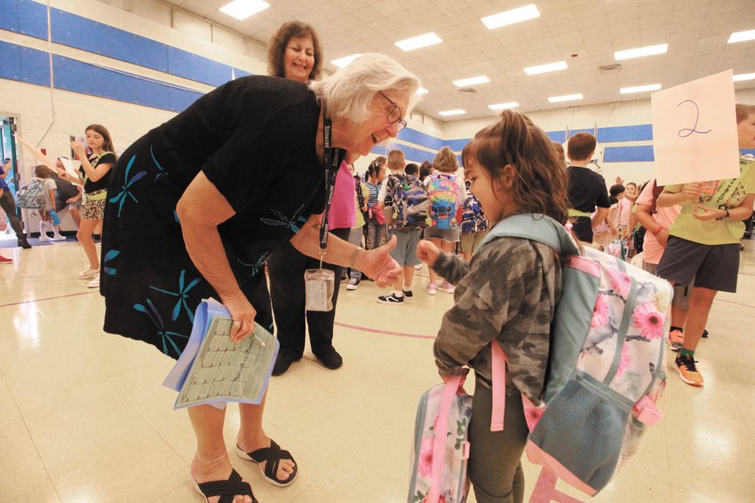FIRST DAY JITTERS: Paula Bennett knew just what to do and say as bewildered Hoxsie kindergartners weren&rsquo;t sure of where to go and, in some cases, couldn&rsquo;t remember their names. (Warwick Beacon photos)