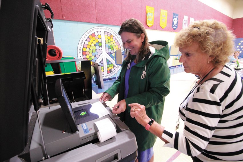 a vote for fox: Cranston native and former Herald editor, Joy Fox, who ran for the Democratic nomination for the Second Congressional District. Now a resident in Warwick , she  was voter 137.  &ldquo;I&rsquo;m feeling lucky with that number,&rdquo; she said. Assisting her is poll worker Janice Costello.