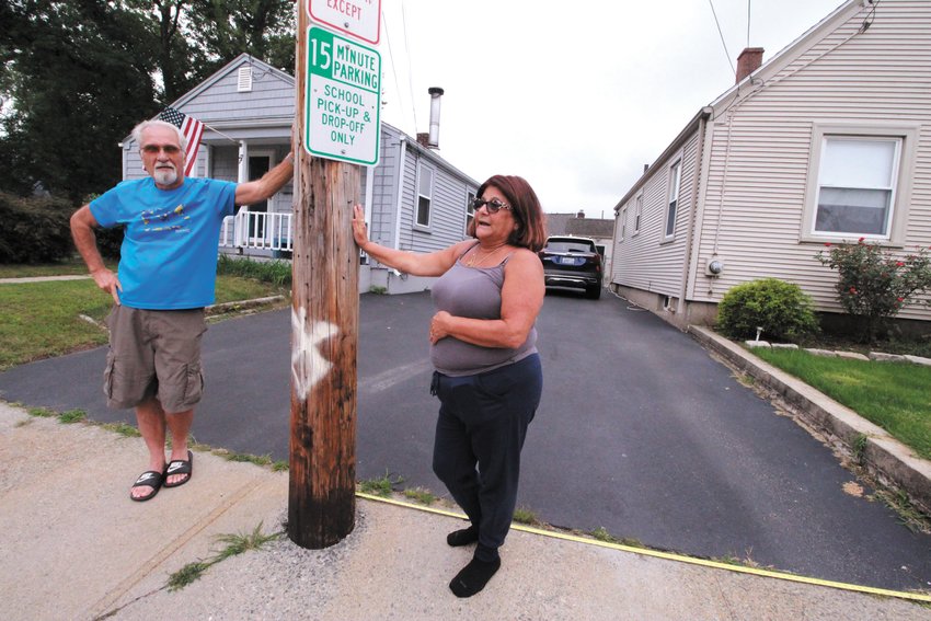 NO MARGIN FOR ERROR: Steve Dionne and Donna Miccolis share a driveway and a utility pole that they agree they would love to get moved, but the city isn&rsquo;t inclined to help even though the pole is embedded in the city sidewalk. (Herald photo)