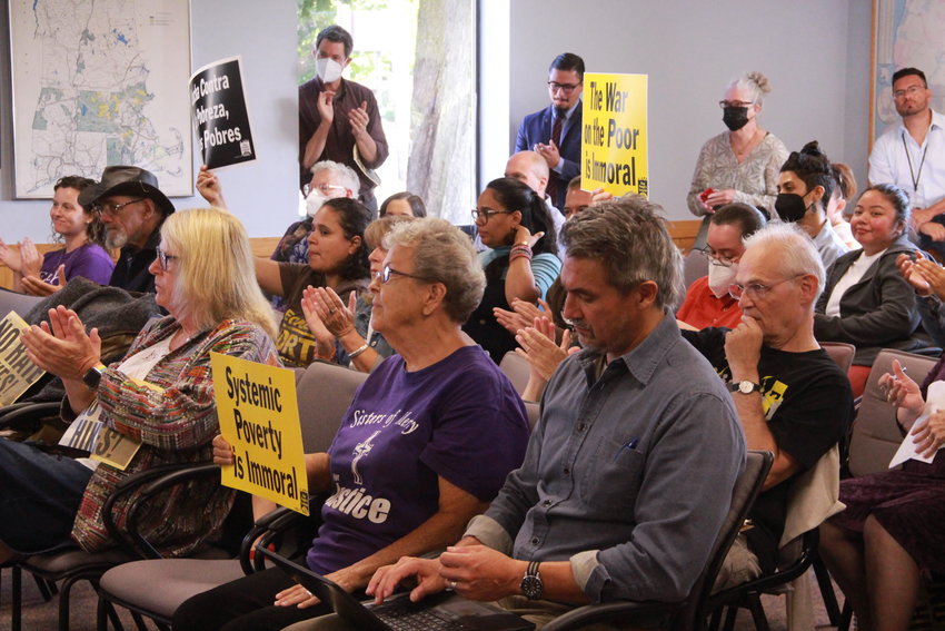 SIGNS OF   PROTEST: Attendees at a public hearing on an increase in electricity rates held signs in protest. The hearing was held in Cranston before the state&rsquo;s Division of Public Utilities and Carriers.