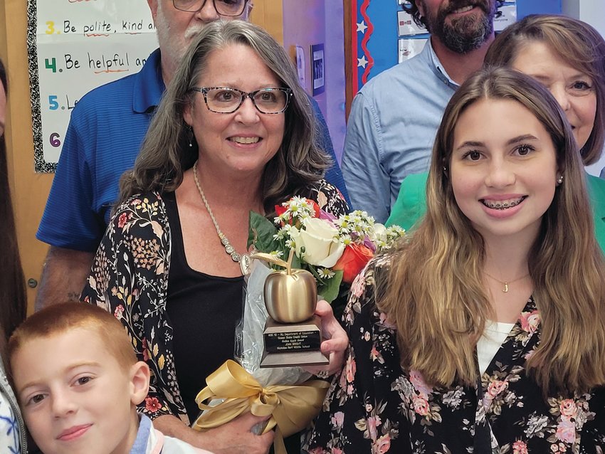 AN INSPIRATION: Nicholas A. Ferri Middle School Teacher Joan Wright held her &ldquo;Golden Apple&rdquo; close to her heart after the award ceremony last week.