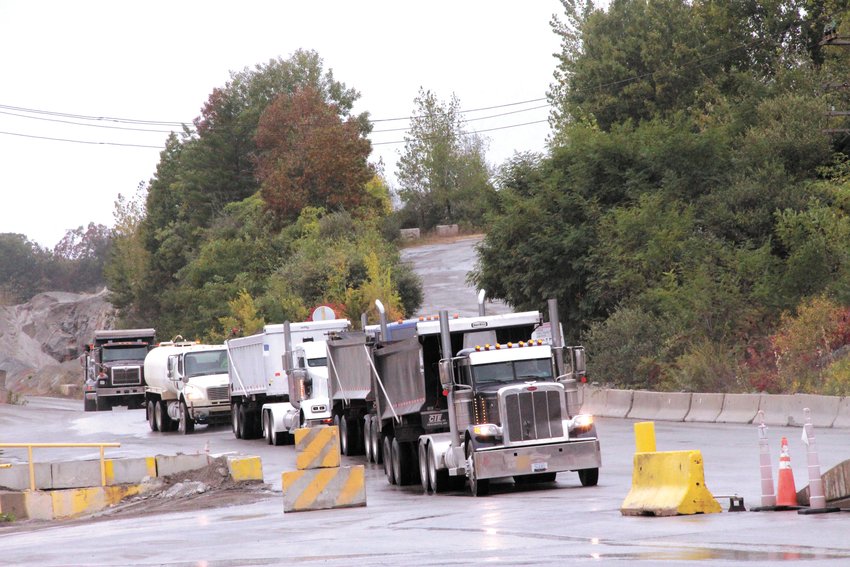 A CONSTANT STREAM: There seemed to be no end to the line of trucks leaving P.J. Keating Company on Phenix Avenue Tuesday to meet the demand for aggregate needed for ongoing repaving projects across the state. (Cranston Herald photo)