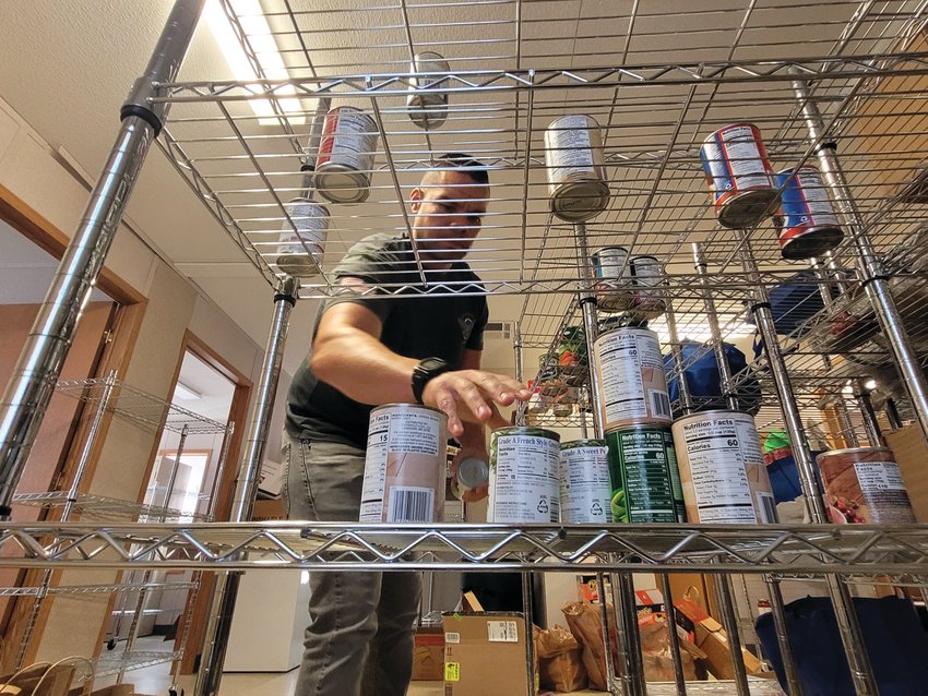 EMPTIED SHELVES: Tyrone &ldquo;Ty&rdquo; Smith, Director of Employment and Housing for Operation Stand Down Rhode Island (OSDRI), surveys the organization&rsquo;s food bank shelves. The group needs help collecting food for the region&rsquo;s veterans.