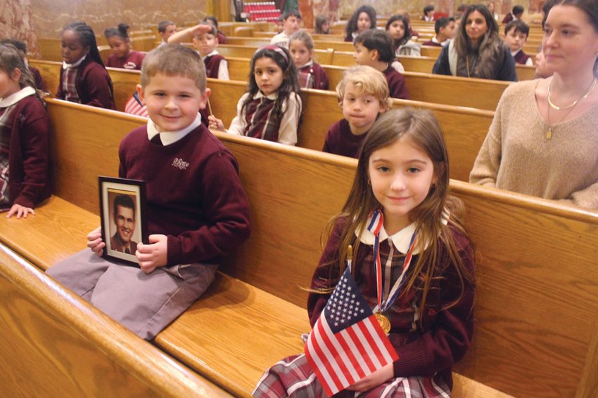 PRAYERS FOR OUR PROTECTORS: First grade students Mila Paolucci and Nicholas Innocenti attended St. Rocco School&rsquo;s Veterans Day Prayer Service on Wednesday, Nov. 9. Innocenti held a photo of his great-grandfather, a veteran.