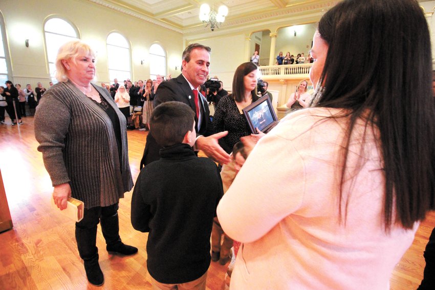 MEETING THE CROWD: Mayor Frank Picozzi accepts the congratulations of those attending his inauguration at City Hall. Behind him is his wife, Kim and to his left is his daughter, Jackie and in front is his grandson, Benny. (Warwick Beacon photos)