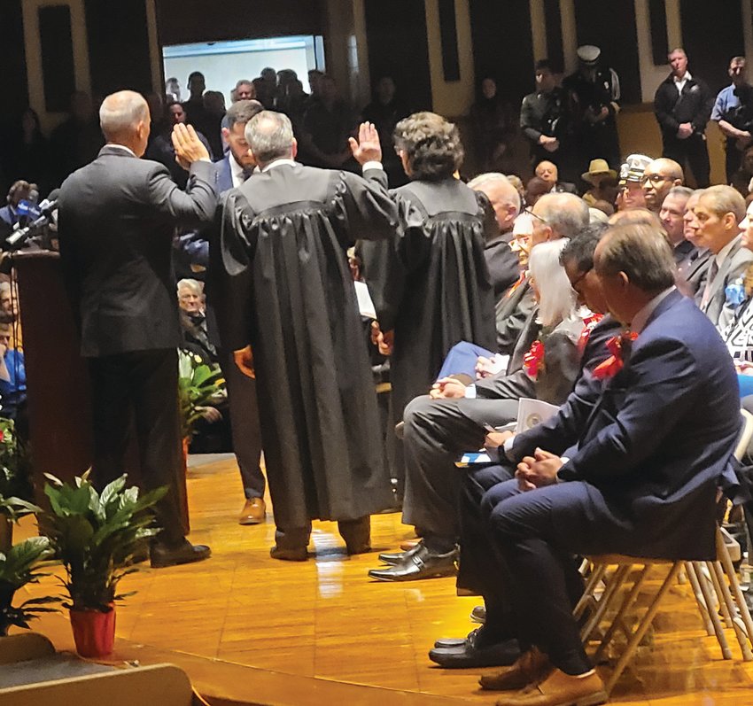 NEW JUDGES: Joseph Polisena Jr. swore in three judges on Inauguration Night, Jan. 9: Judge of the Johnston Municipal Court, David aRusso; Frank Manni as Auxiliary Judge; and Priscilla Facha DiMaio, Probate Judge. Town Council member Robert Civetti is seated on the right, watching the oath delivered following his vote against the appointment of aRusso, now-former Judge Jacqueline M. &nbsp;Grasso&rsquo;s replacement.