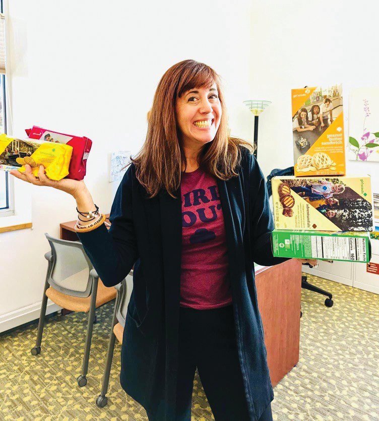 IT&rsquo;S COOKIE SEASON: Girl Scouts of Southeastern New England (GSSNE) CEO Dana Borrelli-Murray poses with some of the Girl Scout cookie options available for purchase. The organization is currently in cookie season and, last year, the GSSNE council sold 750,000 cases of cookies; each case holds 12 boxes. (Submitted photo)