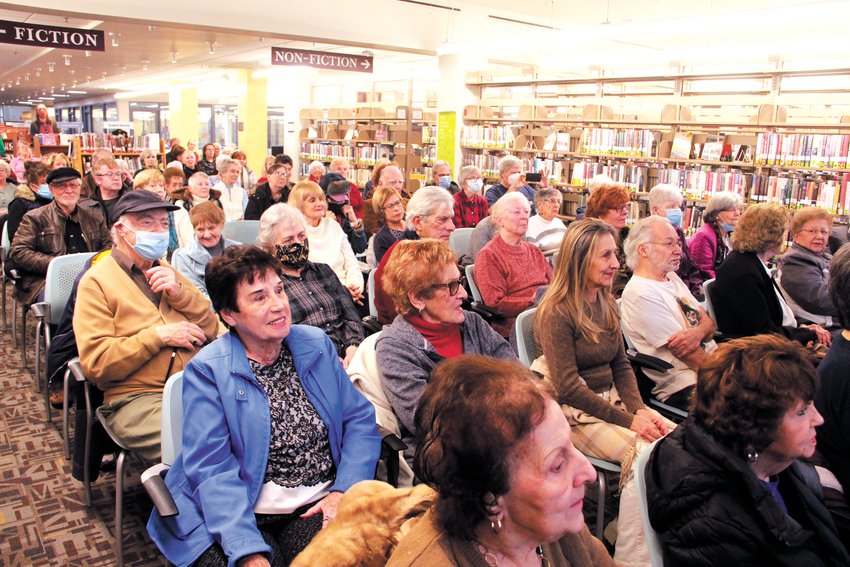 PACKED BETWEEN THE AISLES: The library&rsquo;s community room couldn&rsquo;t accommodate the turnout, so concert goers booked on finding a seat among the shelves.